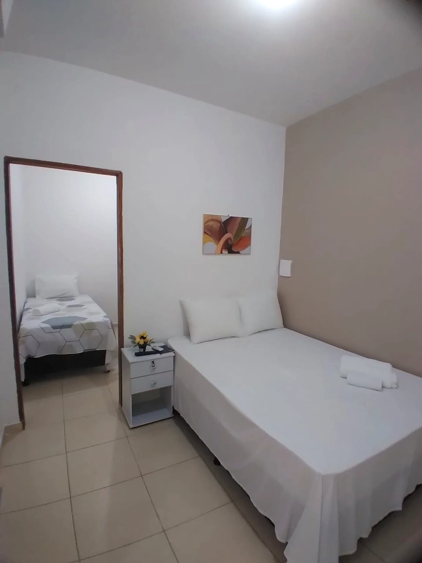 Quarto 4 — área de descanso com frigobar